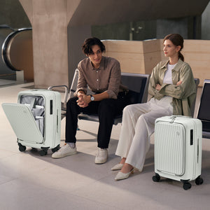 Couple waiting at gate with OIWAS SMOOTH 20” suitcases