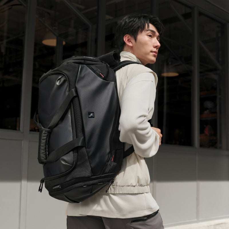 ELEPHANTOM travel bag shown being carried as a backpack, shoulder bag, and by hand — versatile carry options for any journey.