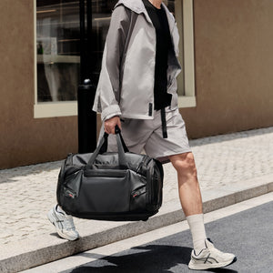 Traveler using the ELEPHANTOM multifunctional travel bag at a street