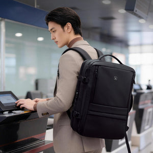 Expandable 17-inch anti-theft laptop backpack with USB charging port, lifestyle photo showing daily use