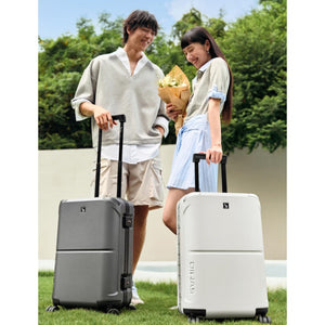 Two people with suitcases outdoors, one holding flowers – OIWAS Horizon X Series Aluminum Frame Carry on Luggage