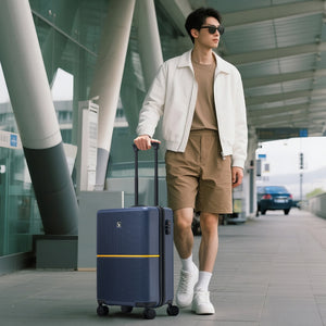Man walking with a OIWAS Edge Collection suitcase in an airport terminal