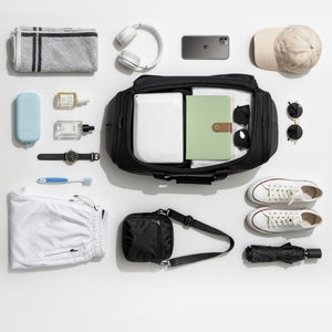 ELEPHANTOM multifunctional travel bag positioned next to common objects for size reference, emphasizing its spacious design