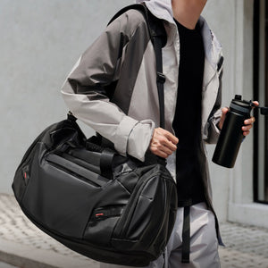 ELEPHANTOM travel bag shown being carried as a tote — versatile carry options for any journey.