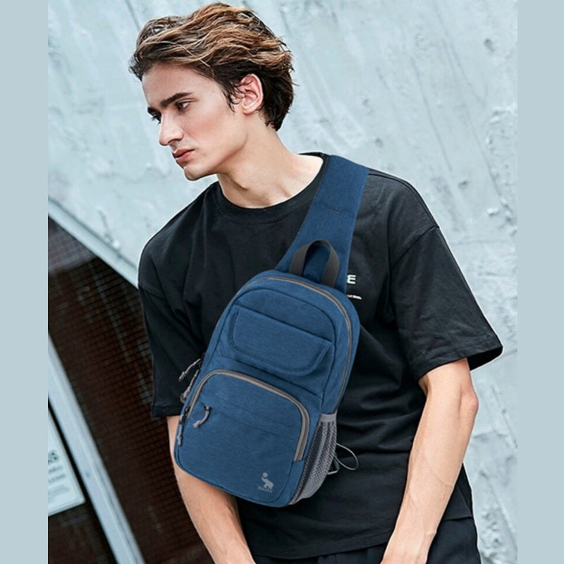 OIWAS blue sling bag worn crossbody by man during urban commute