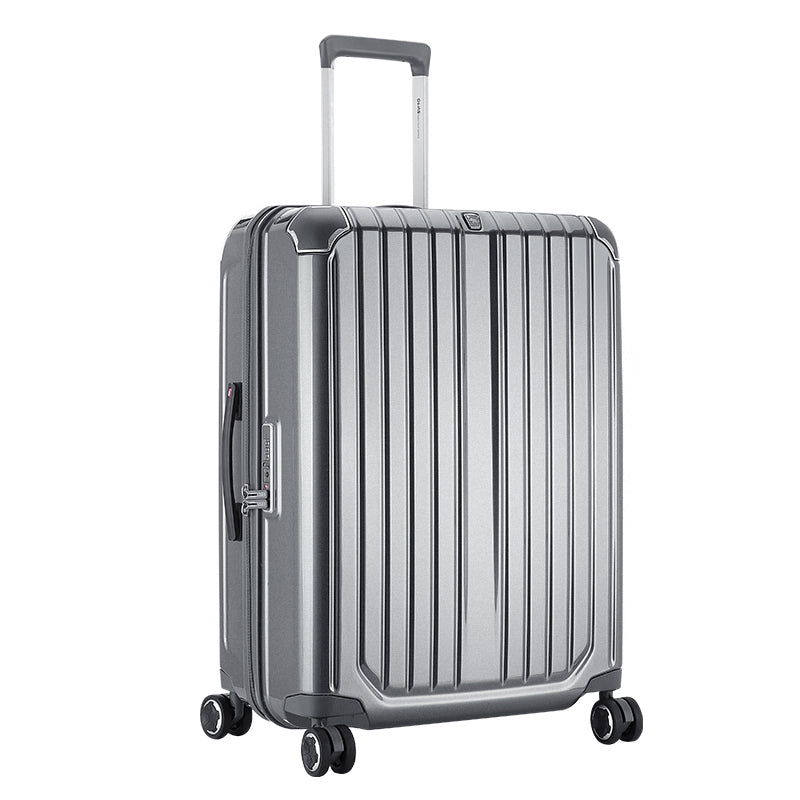 Angled shot of silver CLAD luggage under studio lighting, emphasizing reflective finish and precision craftsmanship.