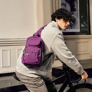 OIWAS purple sling bag worn crossbody by man during urban commute