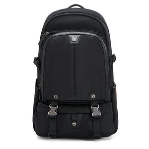 OIWAS TRIUMPH waterproof travel backpack in urban setting, featuring sleek black design, front organizer pockets, and trolley pass-through strap.