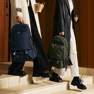 Traveler wearing OIWAS TRIUMPH anti-theft backpack while walking through airport — lightweight and carry-on compliant.