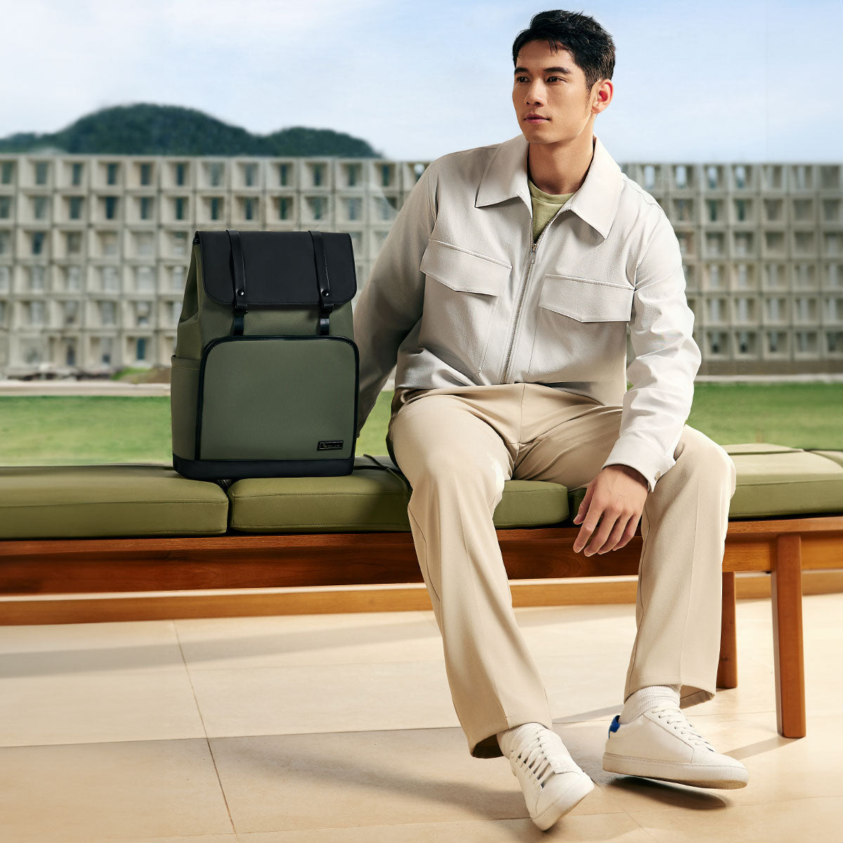 OIWAS VANGUARD 16-inch laptop backpack in an urban setting, featuring a sleek design with front organizer pockets and trolley sleeve for attaching to rolling luggage