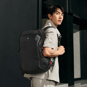 OIWAS ELEPHANTOM 16-inch laptop backpack with trolley sleeve, worn by traveler in urban setting — sleek, lightweight design for daily commute and business travel