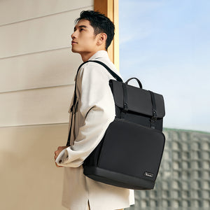 OIWAS VANGUARD 16-inch laptop backpack in an urban setting, featuring a sleek design with front organizer pockets and trolley sleeve for attaching to rolling luggage